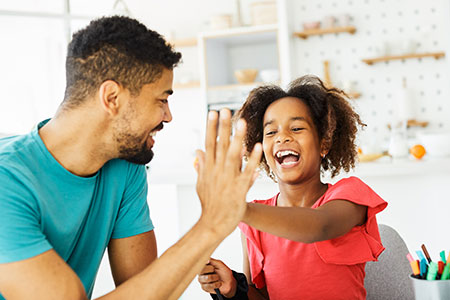Dad and daughter high-fiving